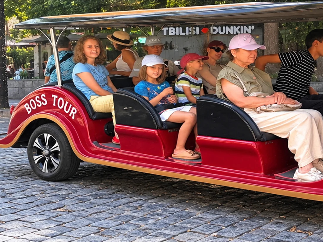 A red retro car with guests on a Tbilisi city tour